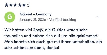 Positive 5-star review praising friendly and attentive guides.