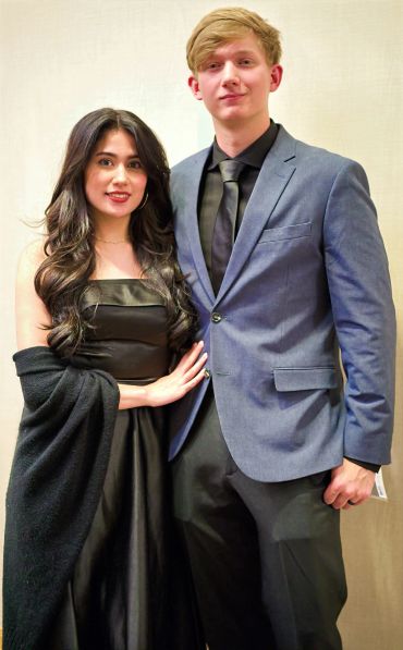 Couple dressed elegantly for an event.