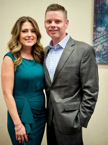 A smiling couple posing for a photo together.