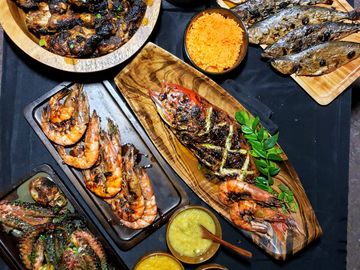 Grilled jamaican jerk chicken, octopus, calamari, prawns and whole fish