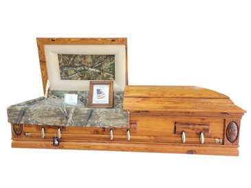 A casket with a rustic red satin finish with a white background