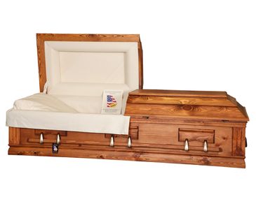 A casket with a flat top lid and rustic red rubbed finish