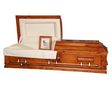 A casket with a flat top lid and rustic red finish with a white background
