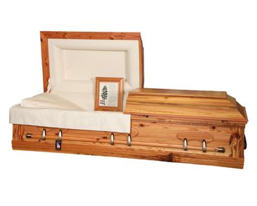 A casket with a flat top lid and natural satin finish