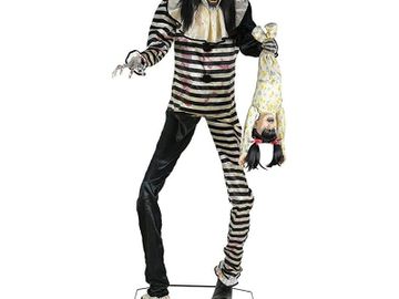 animated clown prop in black and white striped clown suit with stringy black hair halloween decor.