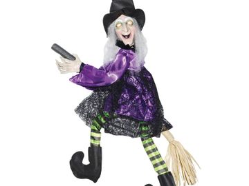 20" tall witch flying on a broom animated halloween decoration.