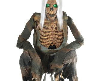 crouching skeleton halloween animated prop with ragged clothing and long white hair and glowing eyes