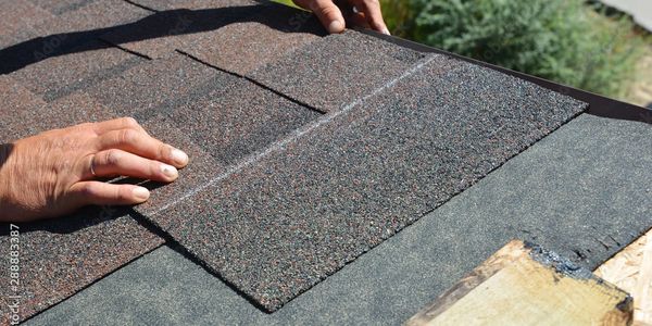 repairing a roof with new shingles