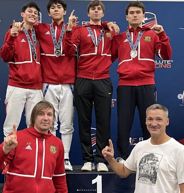 Golden State Fencers with coaches on the gold medal podium.