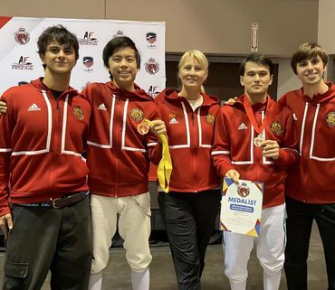 Coaches Nadiya, Akhmad, and Ethan at competition.