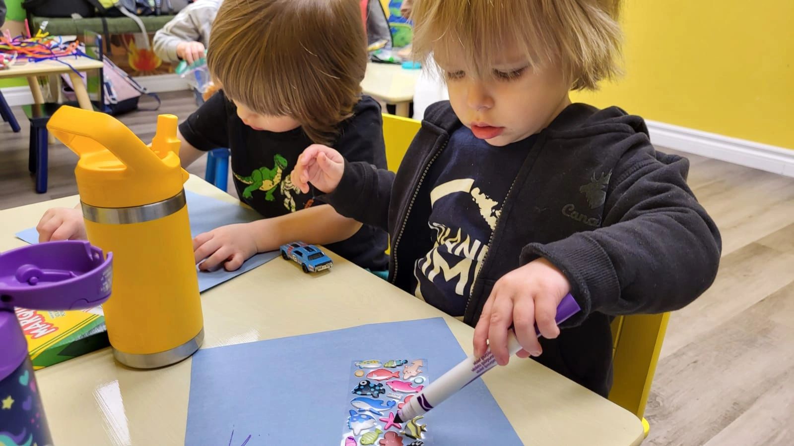Children doing a craft activity during Playtown Niagara PD Day and summer camp in St. Catharines.