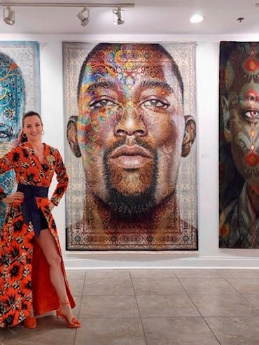 The artist Florencia Clement de Grandprey in front of three of her vast artworks