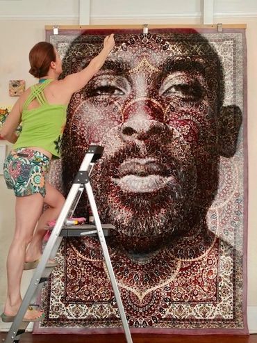 The artists Florencia Clement de Grandprey adds the finishing touches to her work called Kobe