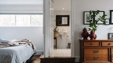 Reset Recovery Clinic 's patient bedroom with a view into private bathroom with a pedestal sink.