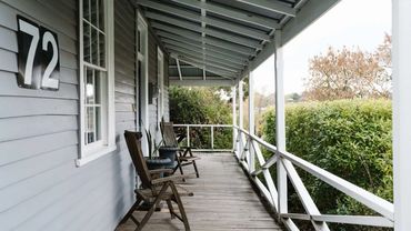 Reset Recovery Clinic - Patient rest area with quiet porch, wooden chairs and greenery outside.