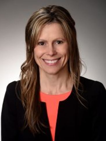 Professional woman smiling in a portrait photo.