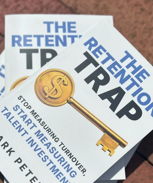Book titled 'The Retention Trap' with a gold key and focus on talent investment.