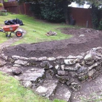 Garden-wheelbarrow filled with soil on a farm