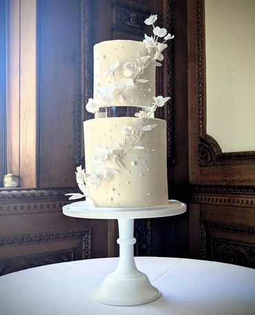 2 tier wedding cake in cream and white with handmade sugar flowers