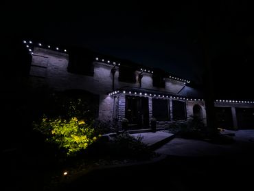 Kleinburg home with permanent white LED soffit lights highlighting the roofline at night.