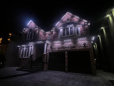 Woodbridge home with cool white permanent outdoor LED lighting installed by Toronto Glow.