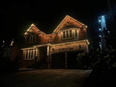 Woodbridge home with warm white permanent outdoor LED lighting installed by Toronto Glow