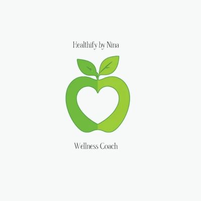 Logo with green apple and heart shape for wellness coaching.