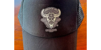 Black Cabeza de Vaca fundraising hat—Souvenirs section color photo.