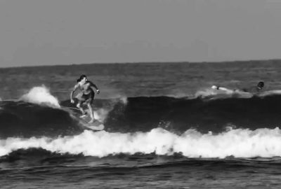Surfer shortboarding at the point break in Playa La Saladita – black and white photo.