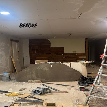 Room under renovation with construction tools and materials scattered around.