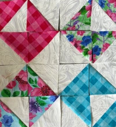 Colorful quilt blocks with checkered and floral patterns.