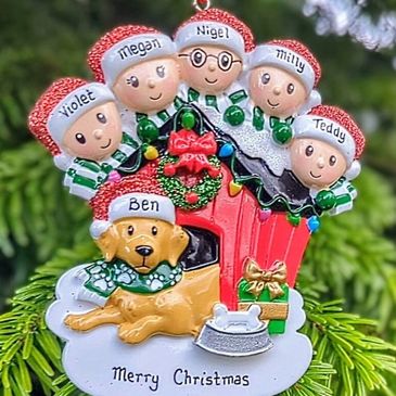 Christmas ornament with five kids' faces and a dog, named individually, on a festive background.