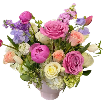 A colorful bouquet of mixed flowers in a white vase.