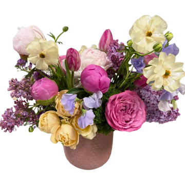 A colorful bouquet of mixed flowers in a pink vase.