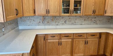 New kitchen countertop and wooden cabinets.