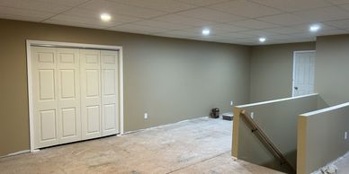 Empty room with beige walls and white closet doors.