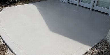 Clean concrete patio with smooth finish and some shading.