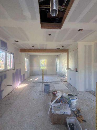 Room under construction with drywall installation.