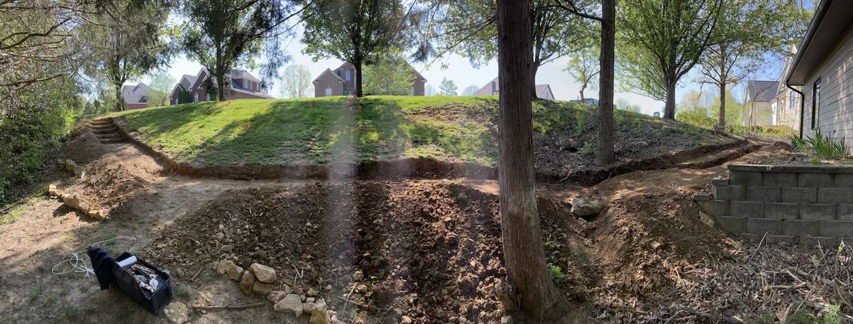 Excavation for base of retaining wall and pathway.