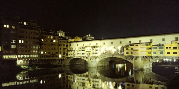 Original photography of buildings in Italy reflected in a water canal.