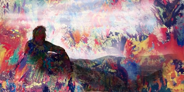 Artistic woman looking over a ridge over layed with a painting.