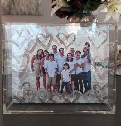A happy family portrait at the beach with heart decorations.