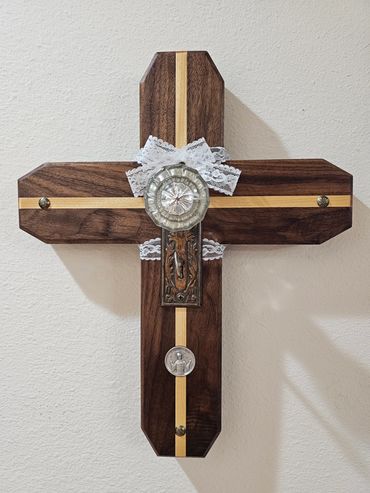 A handcrafted cross crafted from walnut and yellowheart wood, featuring a vintage door knob.