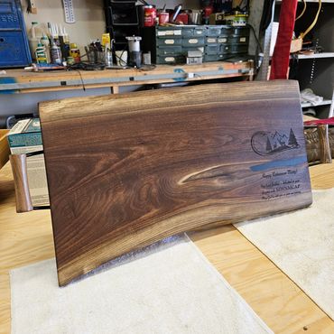 Elegant black walnut cutting board featuring sturdy handles.