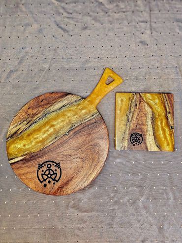 A serving board featuring a stunning gold epoxy river and customized engraving.