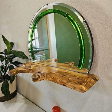 Vintage mirror with green glass trim, complemented by a holly-type wood shelf.