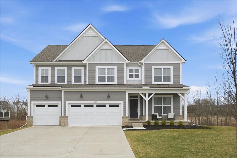 Modern two-story gray house with white trim and a three-car garage.