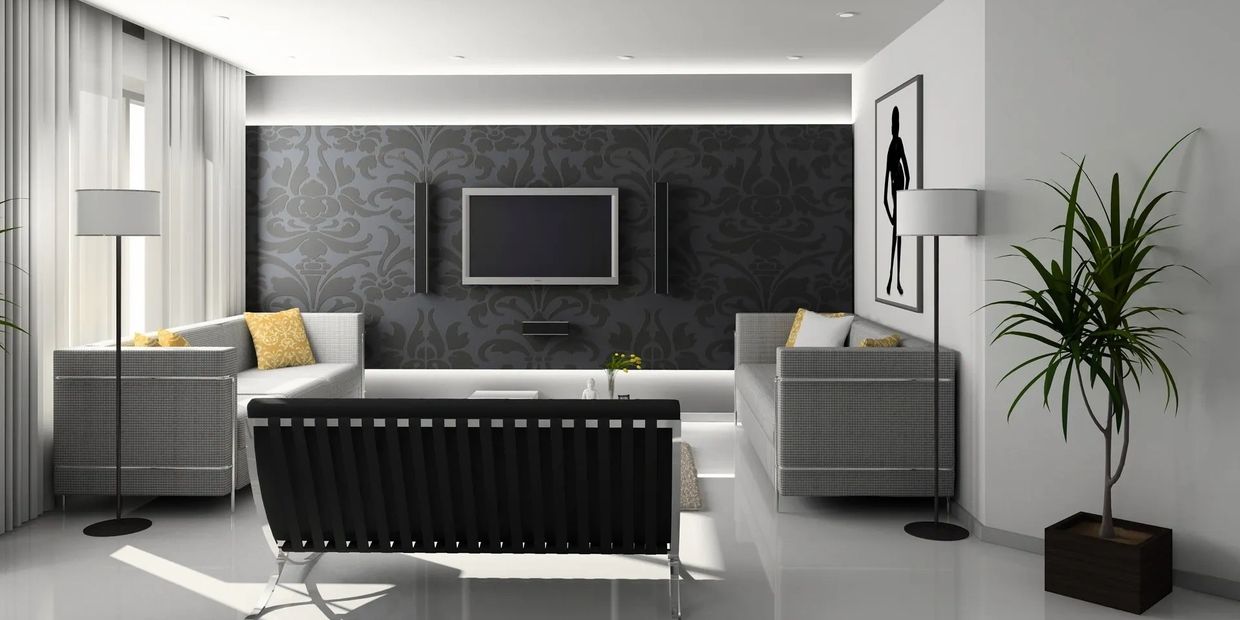 Modern living room with gray sofas, black accent wall, and minimalist decor.