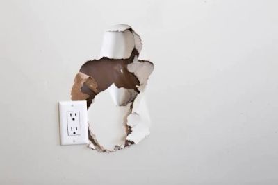Hole in drywall near receptacle outlet