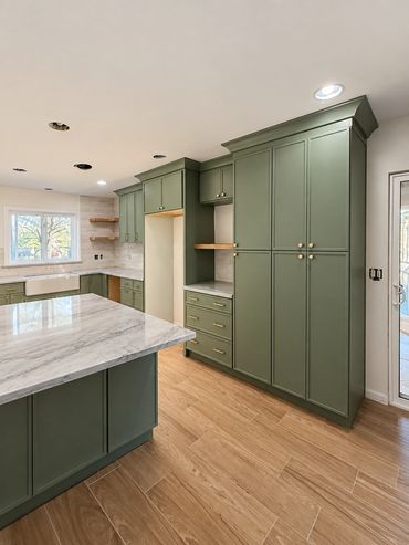 AZT-designed Hemet kitchen with sage cabinets, quartzite countertops and backsplash.